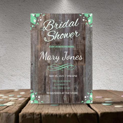 Bridal shower invitation with wooden design and floral elements on a textured surface.